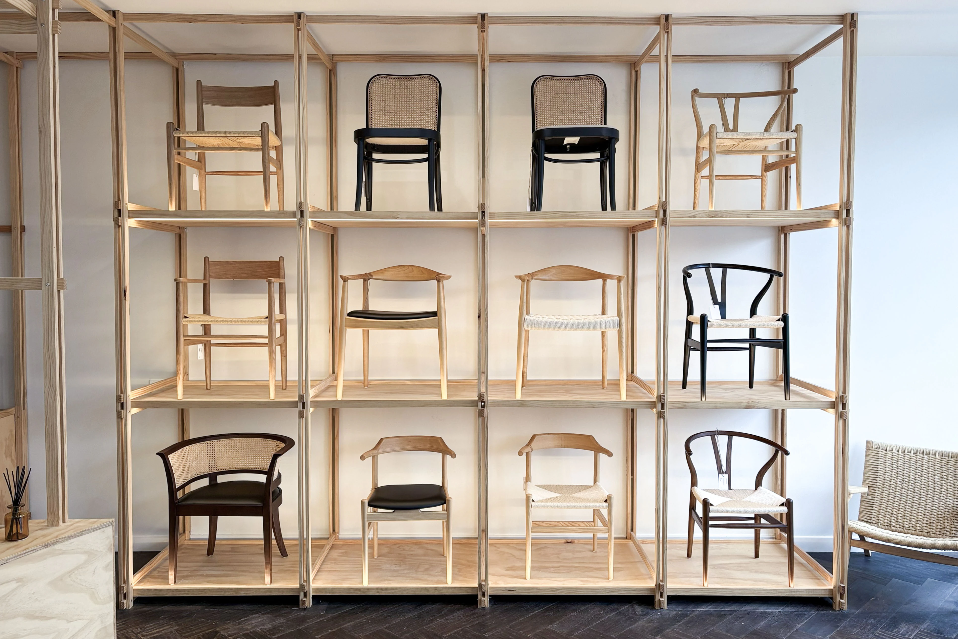 Furniture display integrated into a warm timber shelving system in the Richmond showroom.
