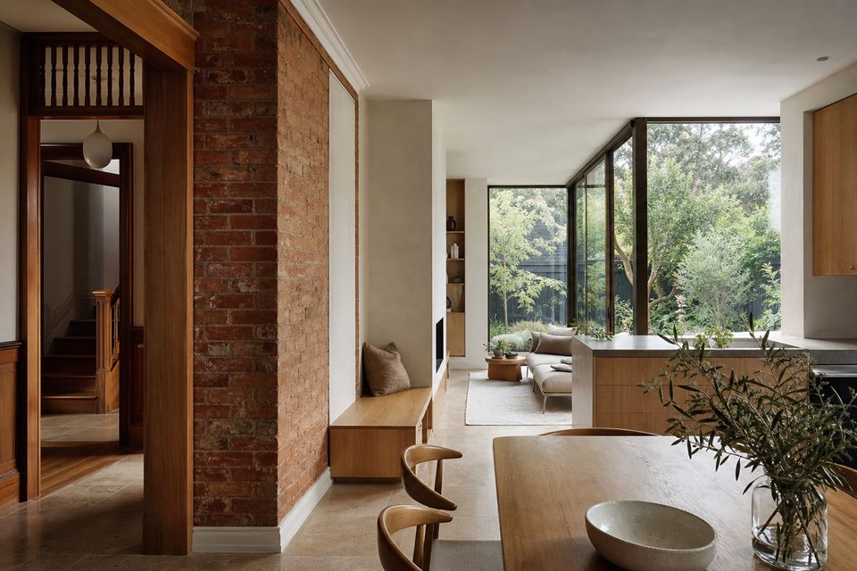Renovated family home interior where retained brick and timber meet a calm modern garden room.