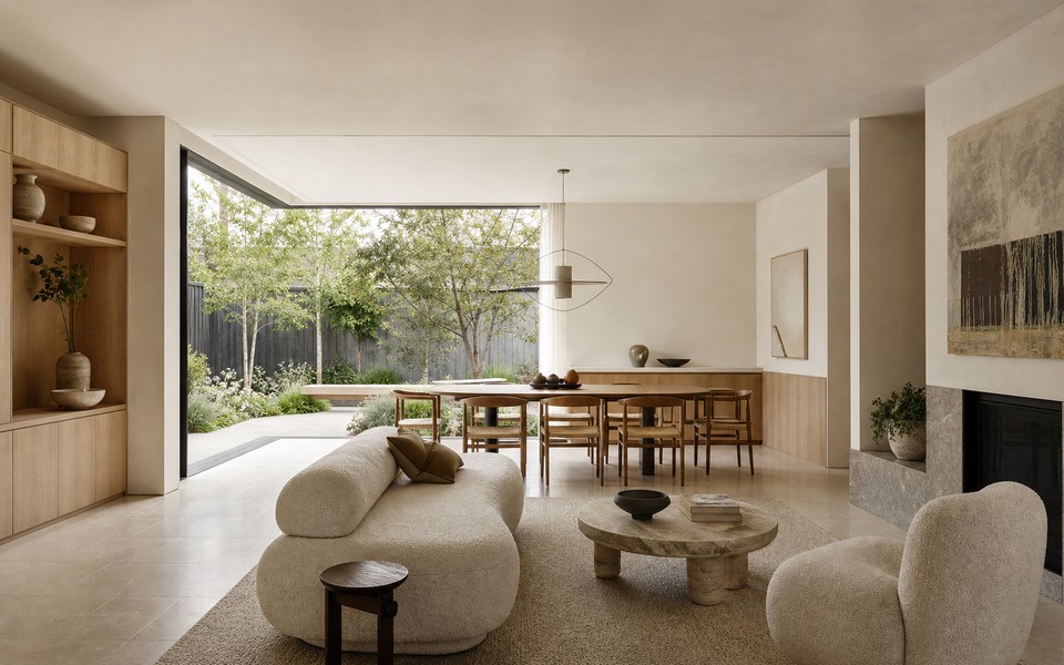 Luxury Australian living and dining room with pale oak, warm limestone and a planted garden.
