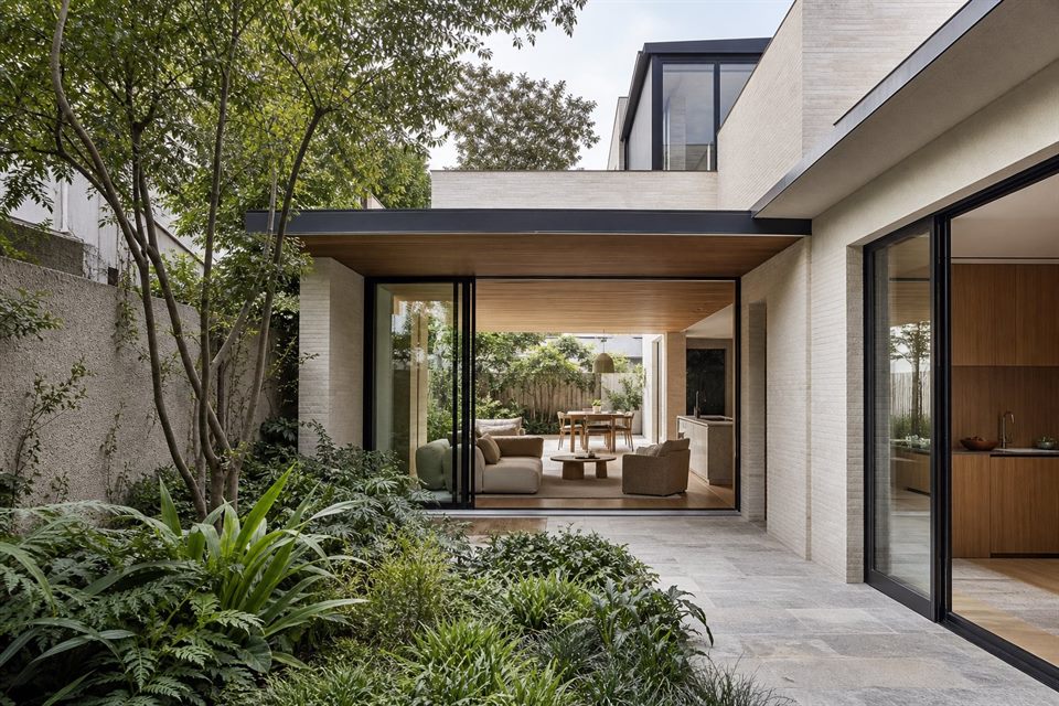 Compact contemporary infill house arranged around a private planted courtyard.